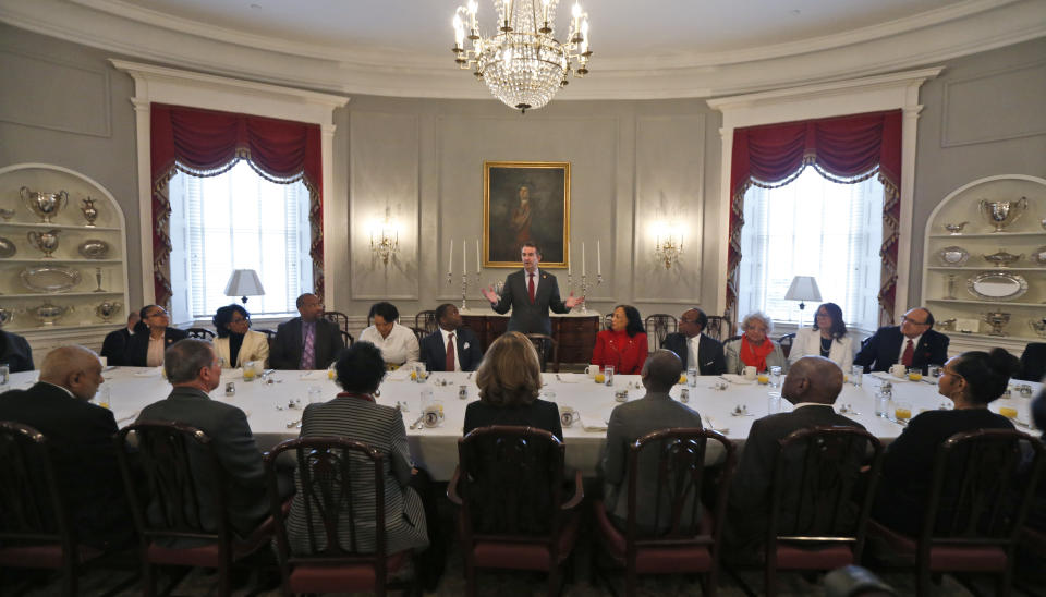 Virginia Gov. Ralph Northam, center top, greets members of the Richmond 34 for a breakfast at the Governors Mansion at the Capitol in Richmond, Va., Friday, Feb. 22, 2019. The Richmond 34 were a group of African Americans who defied segregation laws in the 1960's (AP Photo/Steve Helber)