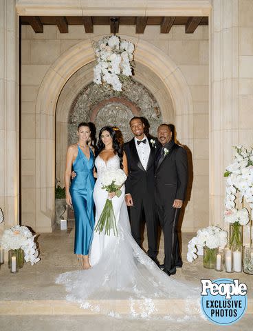 <p>Bradford Martens, The Brothers Martens photography</p> The bride and groom pose with Eddie Murphy (far right) and his fiancée Paige Butcher (far left).