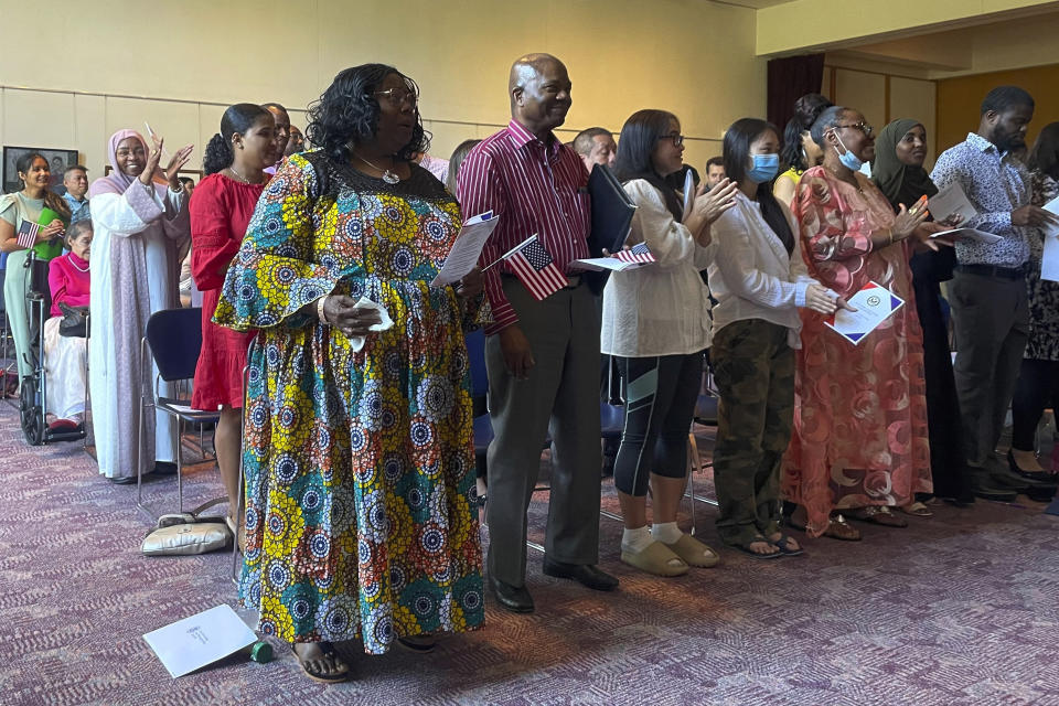 Dozens of people become U.S. citizens during a naturalization ceremony at Mount Zion Temple in St. Paul, Minn., on June 21, 2023. The U.S. citizenship test is being updated and some immigrants and advocates worry the changes will hurt test-takers with lower levels of English proficiency. The test is one of the final steps toward citizenship — a months-long process that requires legal permanent residency for years before applying. (AP Photo/Trisha Ahmed)