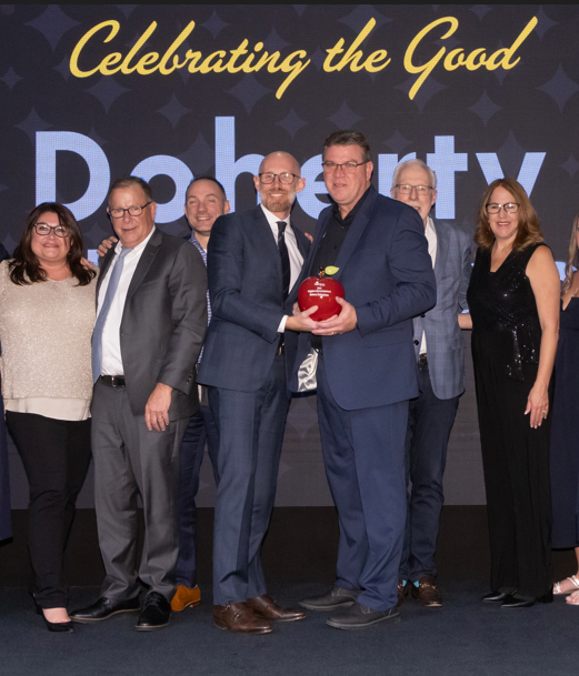 The Doherty Enterprises team accepting the Bill Palmer Heart of Applebee’s Award.