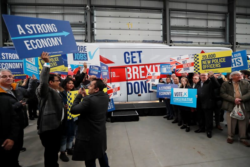 Supporters of Britain's Prime Minister Boris Johnson wait for his arrival at the general election campaign trail bus in Manchester