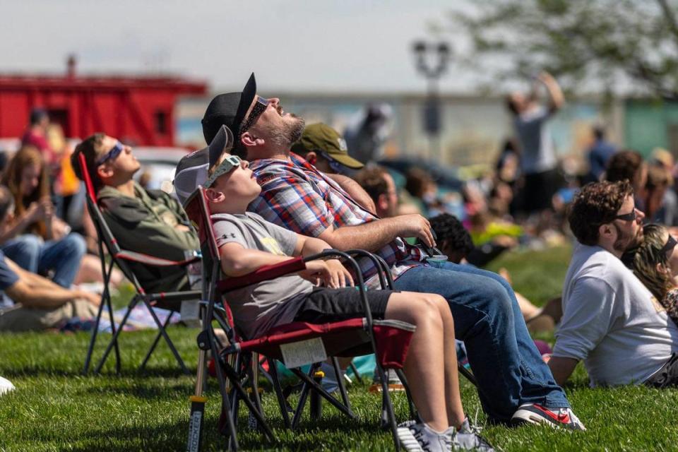 Lorne and Samuel James, 12, of Hendersonville, Tenn., watch a solar eclipse on the riverfront in Paducah, Ky., on Monday, April 8, 2024. Ryan C. Hermens/rhermens@herald-leader.com