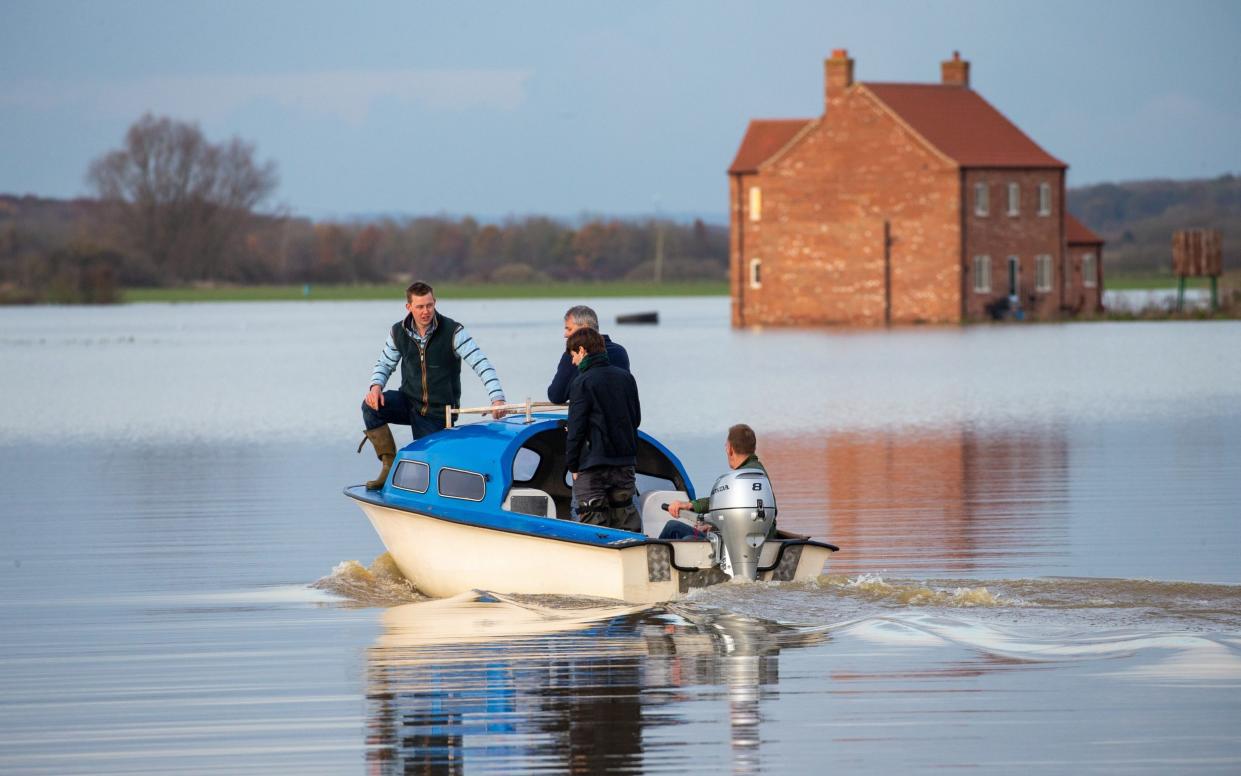 Henry Ward uses a boat to get around after his farmhouse was turned into an island when Barlings Eau burst its banks