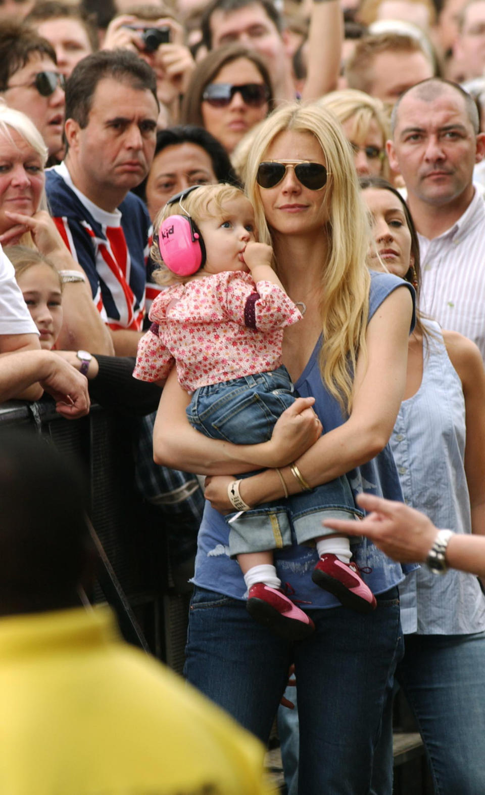 Gwyneth Paltrow and daughter Apple watch, Chris Martin of Coldplay perform on stage.