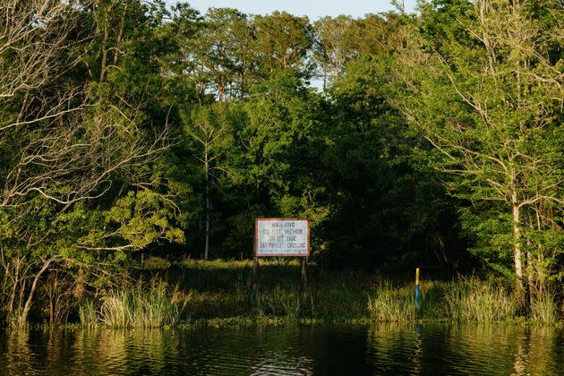 A sign warns of a gas pipeline in Bayou Sorrel. Pipelines for oil, gas and chemical products crisscross southern Louisiana, laid in dredged-out canals that have blocked natural water flows through the Atchafalaya Basin. (Photo: Bryan Tarnowski for HuffPost)