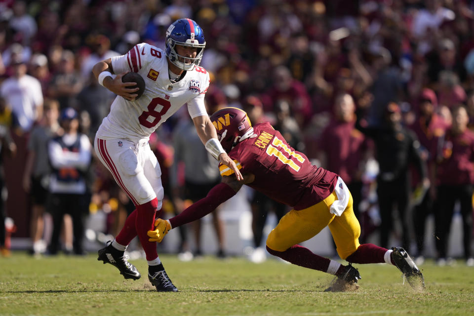 New York Giants quarterback Daniel Jones (8) is tackled by Washington Commanders safety Jeremy Chinn (11) during the second half of an NFL football game in Landover, Md., Sunday, Sept. 15, 2024. (AP Photo/Matt Slocum)