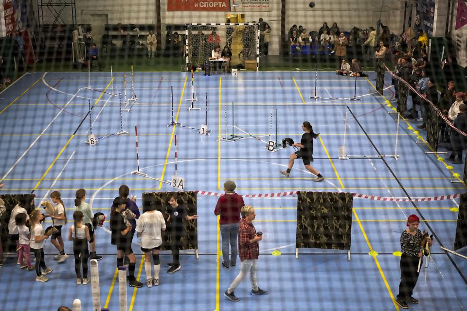 A girl competes during a Hobby horsing competition in St. Petersburg, Russia, on Sunday, April 21, 2024. Several dozen kids, 48 girls and one boy, from first-graders to teenagers gathered in a gymnasium in northern St. Petersburg, Russia's second largest city, for a hobby horsing competition. (AP Photo/Dmitri Lovetsky)