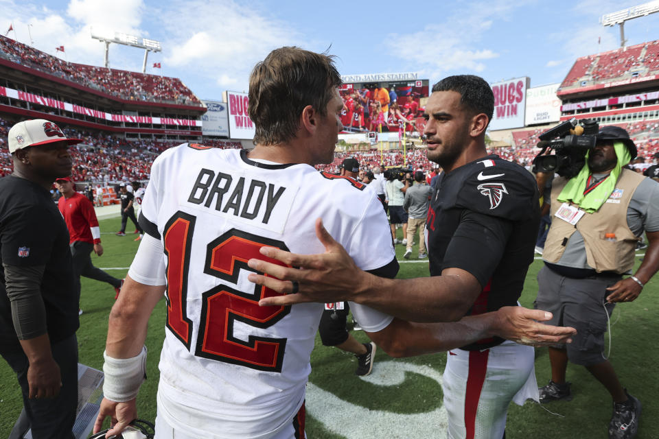 Tampa Bay Buccaneers quarterback Tom Brady (12) and Atlanta Falcons quarterback Marcus Mariota (1) talk after the Buccaneers defeated the Falcons in an NFL football game Sunday, Oct. 9, 2022, in Tampa, Fla. (AP Photo/Mark LoMoglio)