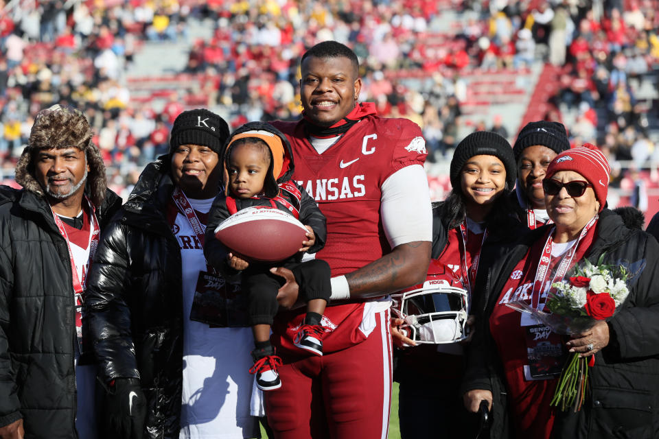 Nov 24, 2023; Fayetteville, Arkansas, USA; Arkansas Razorbacks quarterback KJ Jefferson (1) poses with family during senior presentations prior to the game against the Missouri Tigers at Donald W. Reynolds Razorback Stadium. Mandatory Credit: Nelson Chenault-USA TODAY Sports