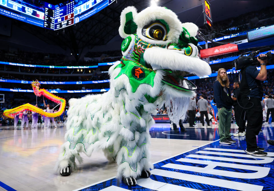 Feb 10, 2024; Dallas, Texas, USA; Dallas Mavericks celebrate the Lunar New Year with performers during the game against the Oklahoma City Thunder at American Airlines Center. Mandatory Credit: Kevin Jairaj-USA TODAY Sports