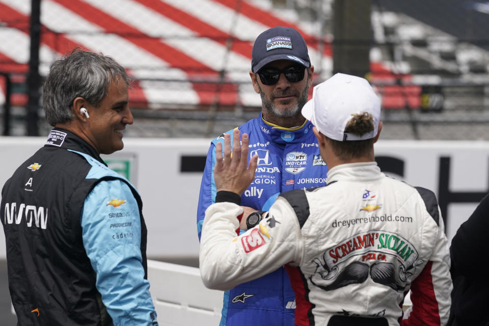 Jimmie Johnson, middle, talks with Juan Pablo Montoya, left, of Colombia, and Santino Ferrucci before practice for the Indianapolis 500 auto race at Indianapolis Motor Speedway, Monday, May 23, 2022, in Indianapolis. (AP Photo/Darron Cummings)