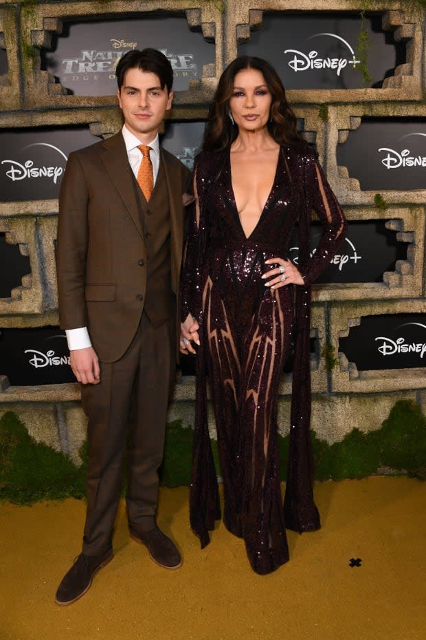 LOS ANGELES, CALIFORNIA - DECEMBER 05: (L-R) Dylan Michael Douglas and Catherine Zeta-Jones attend the Disney+ Original Series "National Treasure: Edge of History" Red Carpet Event at El Capitan Theatre on <a href="https://parade.com/living/december-holidays-observances" rel="nofollow noopener" target="_blank" data-ylk="slk:December;elm:context_link;itc:0;sec:content-canvas" class="link ">December</a> 05, 2022 in Los Angeles, California. (Photo by Jon Kopaloff/Getty Images)<p><a href="https://www.gettyimages.com/detail/1447052248" rel="nofollow noopener" target="_blank" data-ylk="slk:Jon Kopaloff/Getty Images;elm:context_link;itc:0;sec:content-canvas" class="link ">Jon Kopaloff/Getty Images</a></p>