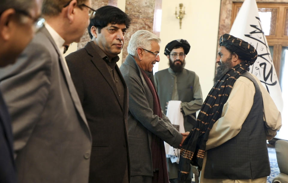 Mullah Abdul Ghani Baradar, the Taliban-appointed deputy prime minister for economic affairs, right, shakes hands with Pakistan's defense minister, Khawaja Mohammad Asif, during a meeting in Kabul, Afghanistan, Wednesday, Feb. 22, 2023. Pakistan's defense minister was in Afghanistan on Wednesday, meeting with officials there in an effort to resolve this week's closure by the Taliban administration of a key border crossing between the two neighboring countries, officials said. (Deputy Prime Minister Minister Office via AP)