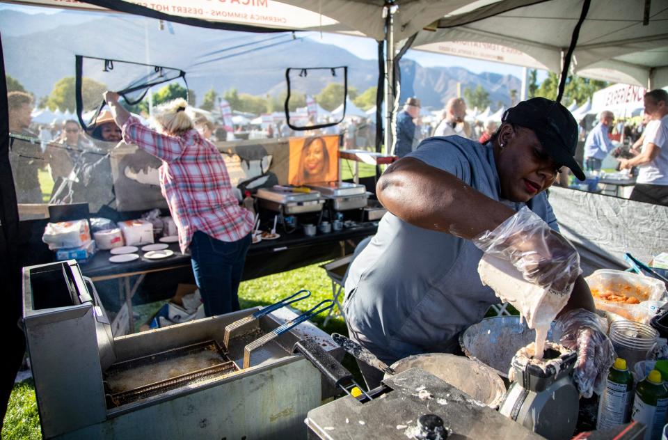 Mica's Soul Kitchen owner Mica Simmons prepares chicken for guests at the Inaugural Palm Springs Wine & Food Experience at Palm Springs Stadium in Palm Springs, Calif., Saturday, Nov. 19, 2022. 