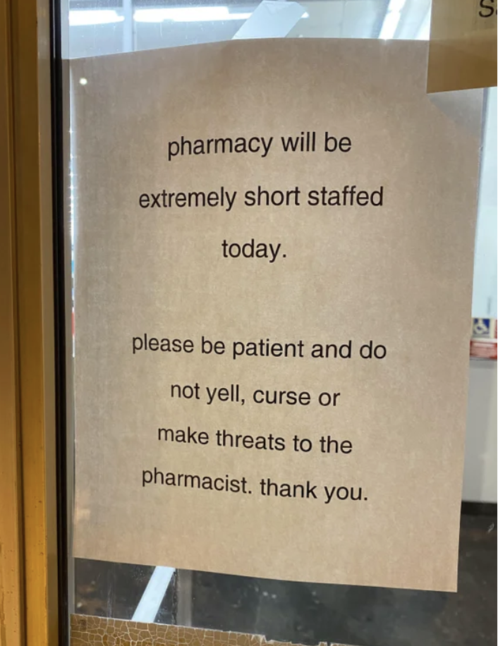 The sign says "Pharmacy will be short staffed today, please be patient and do not yell, curse, or make threats to the pharmacist"