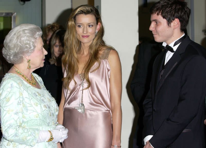 <p>While attending the premiere of <em>The Truman Show, </em>actress Natascha McElhone chatted with Queen Elizabeth while wearing a slinky, pink silk dress.</p>