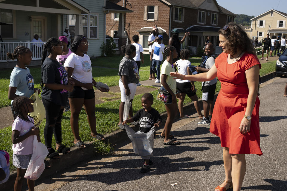 Mayor Indya Kincannon visits with members of the Lonsdale neighborhood during a homecoming celebration Saturday, Aug. 5, 2023 in Knoxville, Tenn. The city saw a spike in gun deaths in 2020 and 2021, with a gun homicide rate that at one point in 2021 rivaled Chicago's. (AP Photo/George Walker IV)