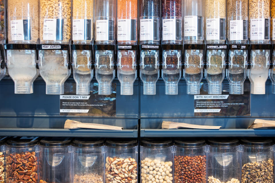 Different varieties of different seeds, beans and nuts on local supermarket shelf. Zero waste shop bulk containers and dispensers with beans and seeds.