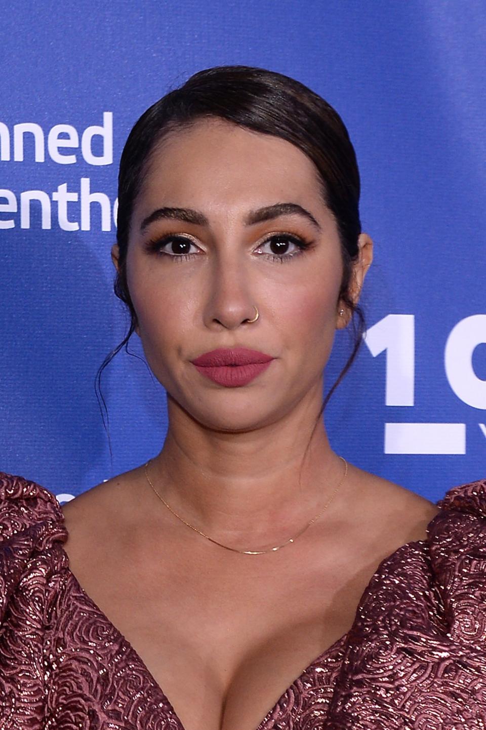 <p>The <em>Orange Is the New Black</em> actress radiates warm-weather beauty with her polished updo with face-framing curls, gold eyeshaodw, lush lashes, and matte rose-pink lips. (Photo: Getty Images) </p>