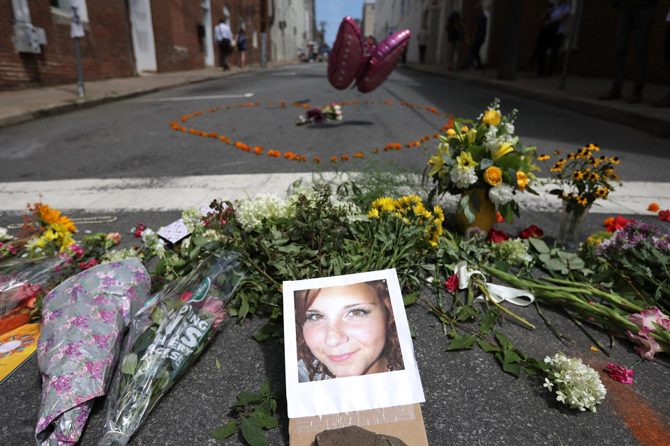 Flowers surround a photo of 32-year-old Heather Heyer, who was killed when a car plowed into a crowd of people protesting against the white supremacist "Unite the Right" rally. (Photo: Chip Somodevilla via Getty Images)