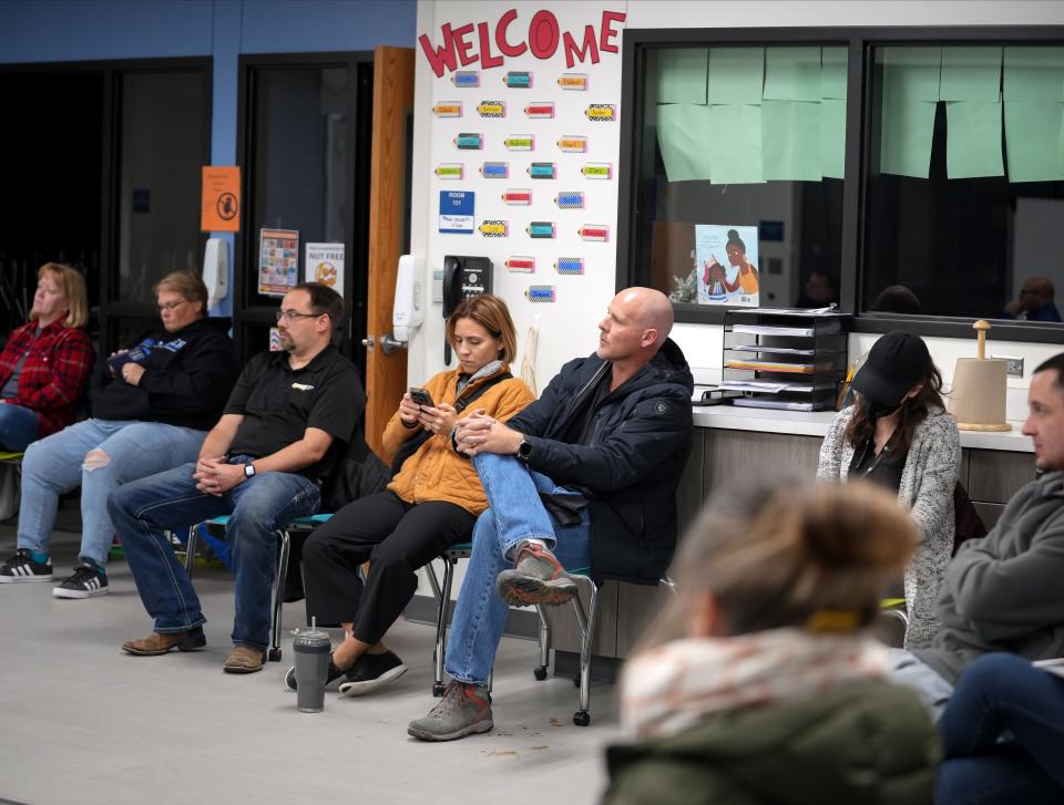 Van Meter parents and community members watch a video presentation during a regular school board meeting on Wednesday, Nov. 16, 2022, in Van Meter.