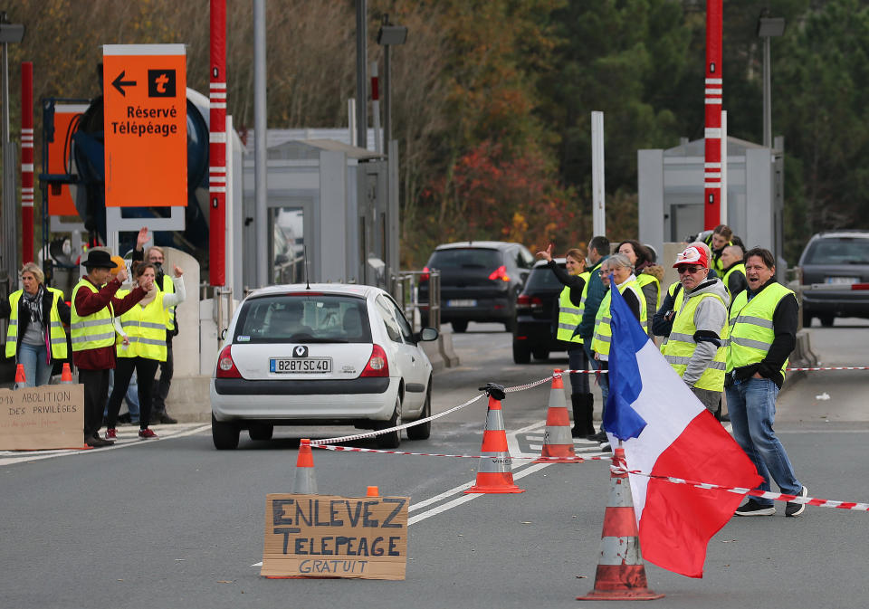 Demonstrators stand near toll gates on a motorway at Biarritz southwestern France, Wednesday, Dec.5, 2018.The concessions made by French president Emmanuel Macron's government in a bid to stop the huge and violent anti-government demonstrations seemed on Wednesday to have failed to convince protesters, with trade unions and disgruntled farmers now threatening to join the fray.(AP Photo/Bob Edme)