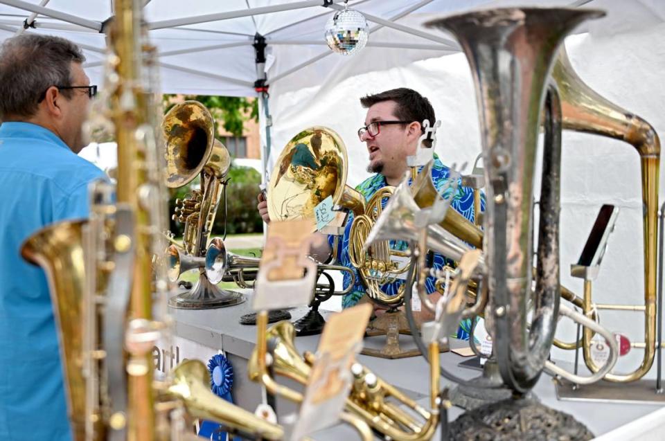 Christopher Locke takes about the musical instruments that he’s transformed into speakers at his booth along Pollock Road at the Central Pennsylvania Festival of the Arts on Thursday, July 11, 2024.