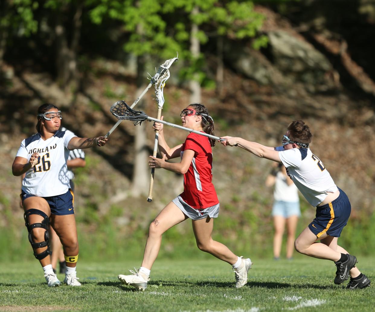 Highland's defense, from left, Amelia Delforno and Sophie Murtaugh attempt to block Red Hook's Maya Anderson during a game on May 8, 2024.