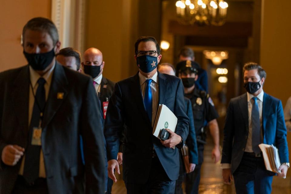 Treasury Secretary Steven Mnuchin, walks from the office of Senate Majority Leader Sen. Mitch McConnell of Ky., as he leaves the Capitol, Wednesday, Sept. 30, 2020, in Washington.