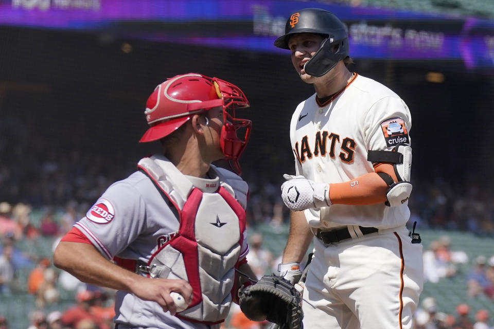 San Francisco Giants' Casey Schmitt, right, reacts after striking out next to Cincinnati Reds catcher Luke Maile during the seventh inning of a baseball game in San Francisco, Wednesday, Aug. 30, 2023. (AP Photo/Jeff Chiu)