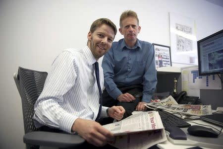 Journalists Darryl Smith (L) and Gavin Sherriff pose for a photograph in The Sunday Post building in Fleet Street in London, Britain August 5, 2016. REUTERS/Neil Hall