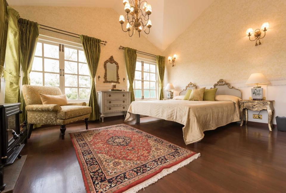 The master bedroom is regal in wood and metallic tones.