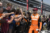 Chase Elliott, right, greets fans during driver introductions before a NASCAR Cup Series auto race at Texas Motor Speedway in Fort Worth, Texas, Sunday, April 14, 2024. (AP Photo/Randy Holt)