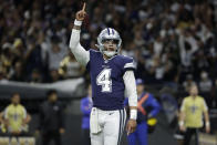 Dallas Cowboys quarterback Dak Prescott (4) celebrates his touchdown pass to Dallas Cowboys wide receiver Michael Gallup during the first half of an NFL football game against the New Orleans Saints, Thursday, Dec. 2, 2021, in New Orleans. (AP Photo/Derick Hingle)