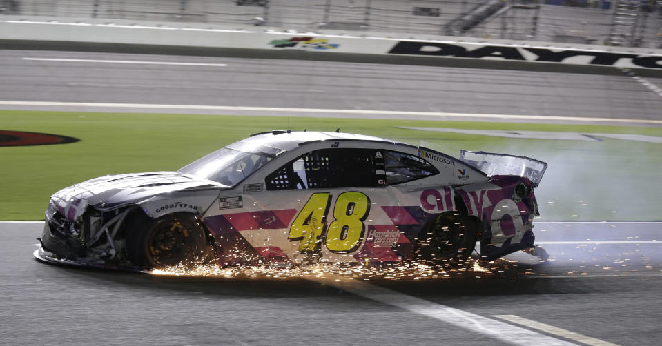 Jimmie Johnson drives his damaged car on pit road during the NASCAR Cup Series auto race at Daytona International Speedway, Saturday, Aug. 29, 2020, in Daytona Beach, Fla. (AP Photo/Terry Renna)