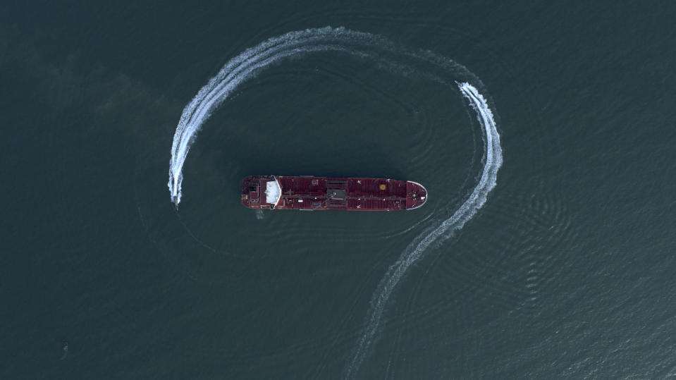 FILE - In this July 21, 2019 file photo, an aerial view shows a speedboat of Iran's Revolutionary Guard moving around the British-flagged oil tanker Stena Impero, which was seized in the Strait of Hormuz by the Guard, in the Iranian port of Bandar Abbas. The U.S. Navy is trying to put together a new coalition of nations to counter what it sees as a renewed maritime threat from Iran. Meanwhile, Iran finds itself backed into a corner and ready for a possible conflict. It stands poised on Friday, Sept. 6, 2019, to further break the terms of its 2015 nuclear deal with world powers. (Morteza Akhoondi/Tasnim News Agency via AP, File)