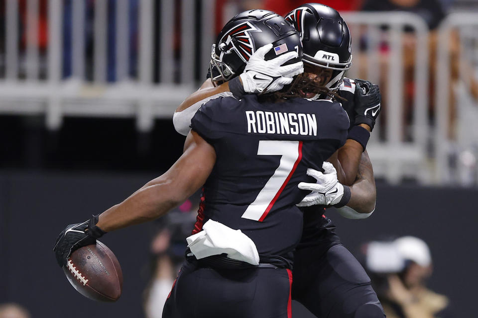 ATLANTA, GEORGIA - SEPTEMBER 10: Bijan Robinson #7 of the Atlanta Falcons and Tyler Allgeier #25 of the Atlanta Falcons celebrate after Robinson's touchdown during the first quarter against the Carolina Panthers at Mercedes-Benz Stadium on September 10, 2023 in Atlanta, Georgia. (Photo by Todd Kirkland/Getty Images)