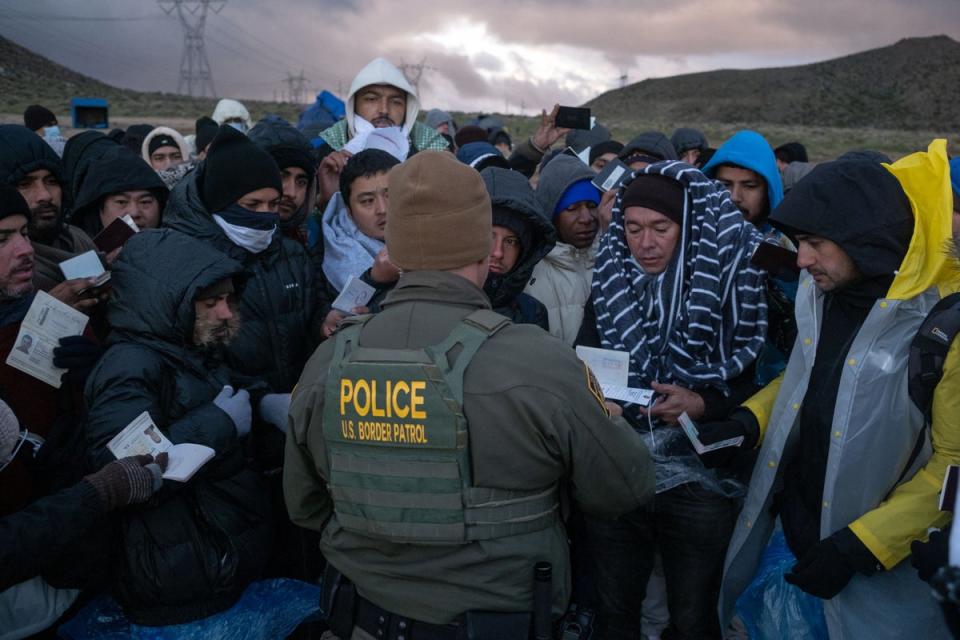 People seeking asylum arrive at the US-Mexico border in California on 2 February (AFP via Getty Images)