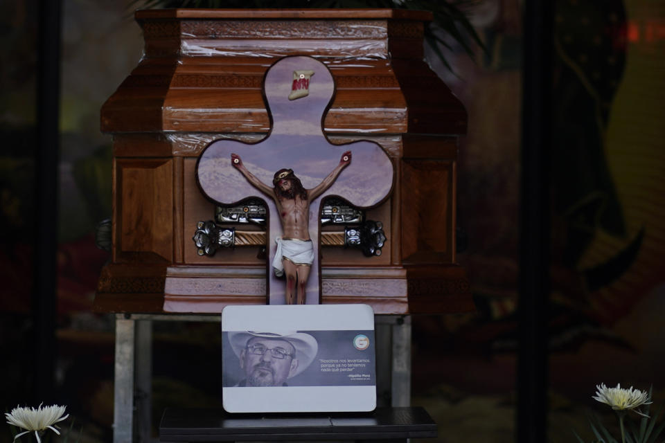 The coffin of Hipolito Mora is on display during his wake held at his home in La Ruana, Mexico, Friday, June 30, 2023. Mora, the leader of an armed civilian movement that once drove a drug cartel out of the western state of Michoacan, was killed Thursday on a street in his hometown. The quote attributed to him on the photo in front of his coffin reads in Spanish: "We rose up because we had nothing to lose." (AP Photo/Eduardo Verdugo)