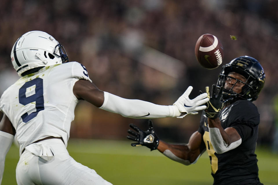 Purdue wide receiver TJ Sheffield (8) catches a tipped ball in front of Penn State cornerback Joey Porter Jr. (9) during the first half of an NCAA college football game in West Lafayette, Ind., Thursday, Sept. 1, 2022. (AP Photo/Michael Conroy)