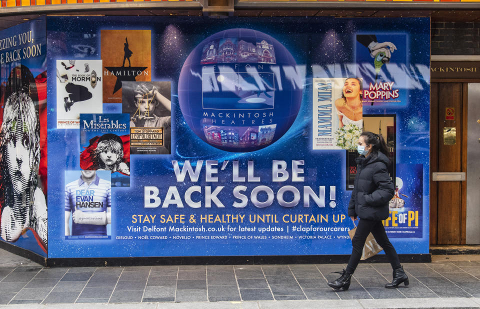 A woman wearing a face mask walks past a new signage with &#x002018;We&#x002019;ll be back soon&#x002019; on the Sondheim theatre completed after Producer Cameron Mackintosh announced that Les Miserables is set to come back to London&#39;s West End by Christmas with tickets going on sale soon after having shut due to the UK entering lockdown. (Photo by Dave Rushen / SOPA Images/Sipa USA)