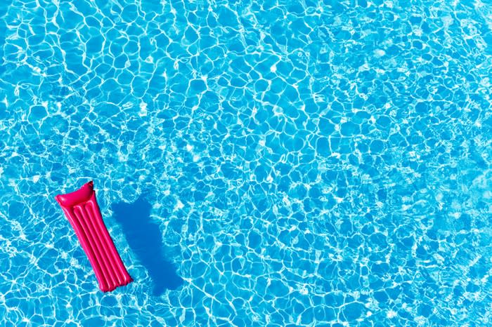 An overhead view of a raft floating in a pool.