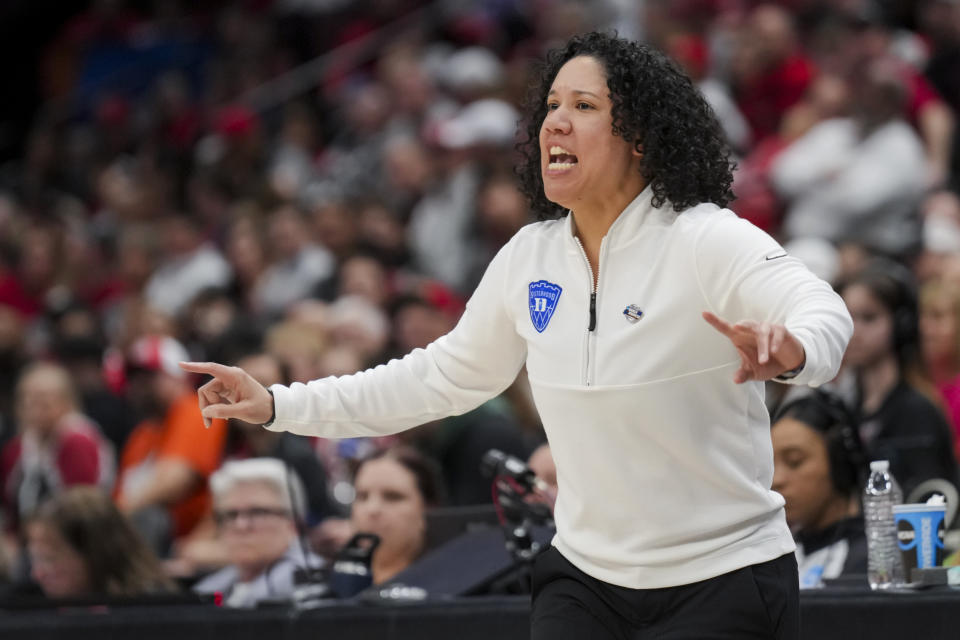 FILE - Duke head coach Kara Lawson works the sideline against Ohio State, March 24, 2024, in Columbus, Ohio. On Monday, June 10, 2024, Lawson hired former Kentucky head coach Kyra Elzy as an assistant, reuniting the former Tennessee teammates on the Blue Devils’ staff. (AP Photo/Aaron Doster, File)