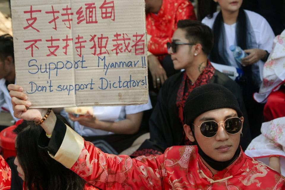 File: Paing Takhon hols a sign during a demonstration against the military coup in Yangon on 11 February 2021  (AFP via Getty Images)