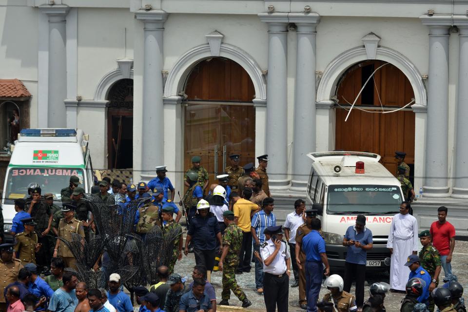 Ambulances are seen outside the church premises with gathered people and security personnel following a blast at the St. Anthony’s Shrine in Kochchikade, Colombo (GETTY)