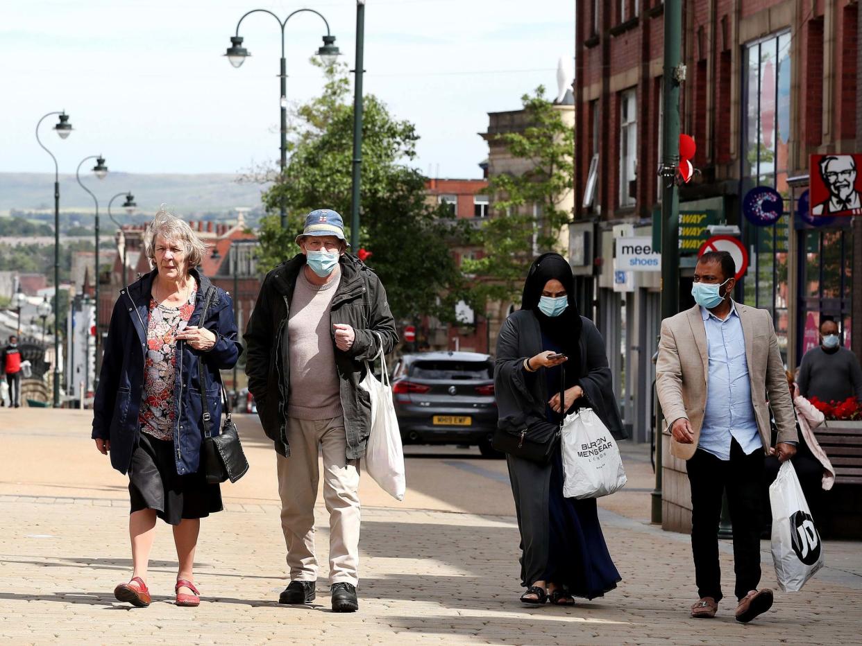 People shopping in Oldham, Greater Manchester, where there has been a rise in coronavirus cases, 30 July 2020: Martin Rickett/PA