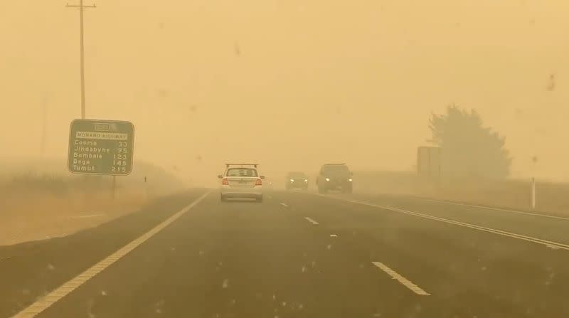 Cars drive in smog on the road to Cooma from Canberra in Bredbo