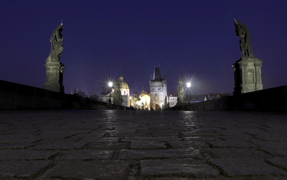 FILE - In this March 28, 2020 file photo a general view of the near empty Charles Bridge in Prague, Czech Republic. (AP Photo/Petr David Josek, File)