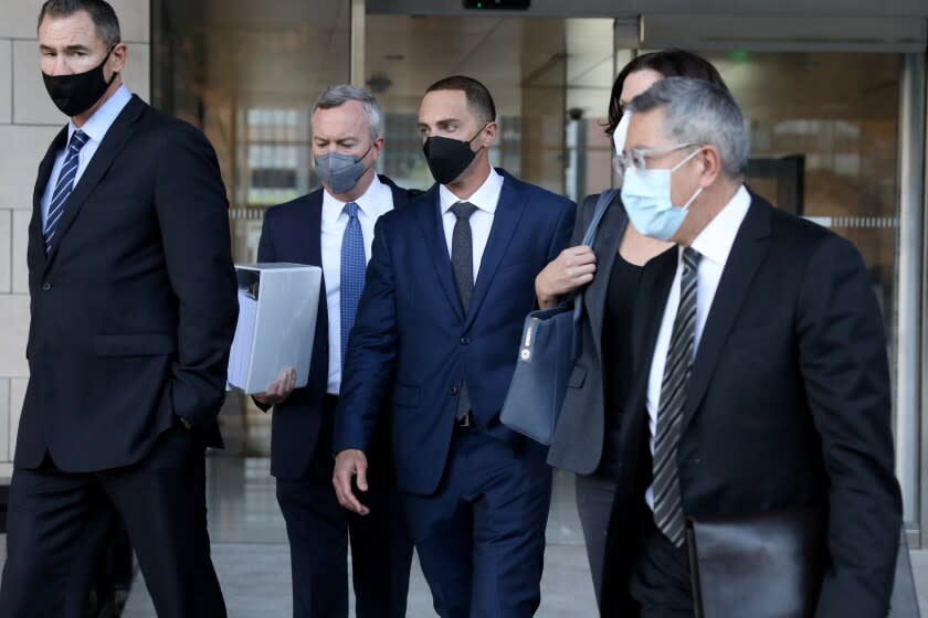 LOS ANGELES, CA - FEBRUARY 14: Horror-film actor Zachary Horwitz, 35, center, flanked by attorneys Ryan Hedges, left, and Anthony Pacheco, was sentenced to a maximum of 20-years by a federal judge for running what prosecutors say is the biggest Ponzi scheme in Hollywood history, as he exitis the U.S. District Court on Monday, Feb. 14, 2022 in Los Angeles, CA. Horwitz is required to pay $230 milliion in restitution to victims and must self surrender on March 14, 2022. He fabricated HBO and Netflix contracts that made it look like he had distribution rights for hundreds of films in markets overseas, but in reality had no deals at all. (Gary Coronado / Los Angeles Times)