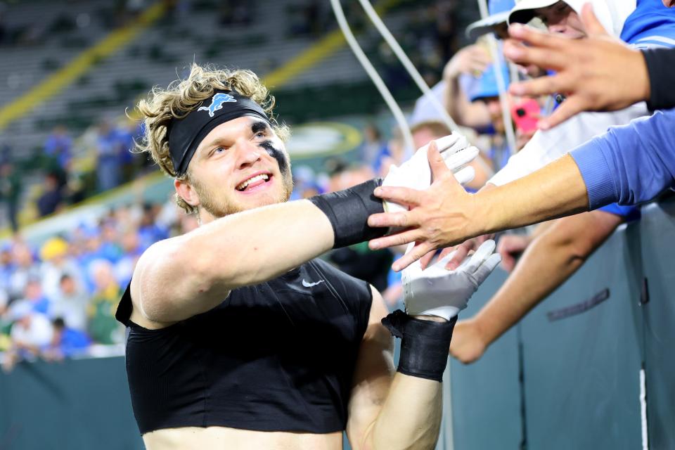 Lions defensive lineman Aidan Hutchinson celebrates with fans after the 34-20 win on Thursday, Sept. 28, 2023, in Green Bay, Wisconsin.